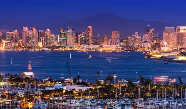 San Diego skyline and bay at night with a marina full of sailboats in the foreground
